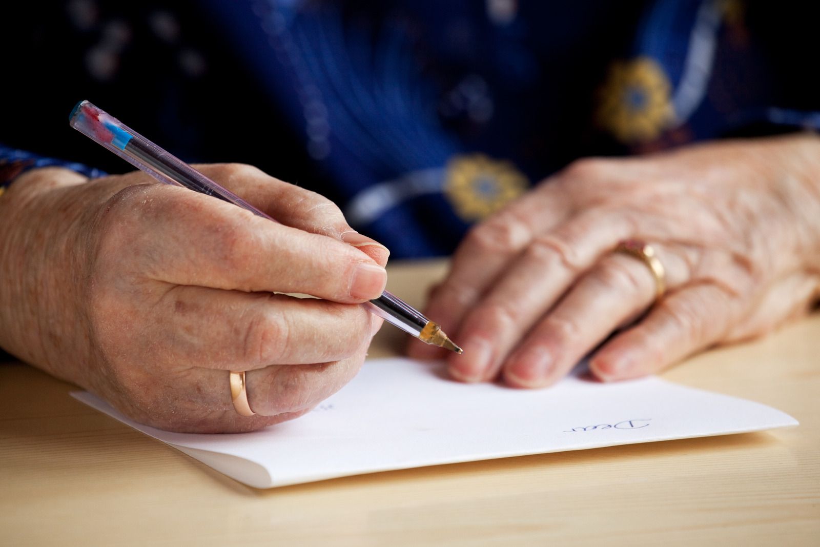 Eine ältere Person schreibt einen Brief