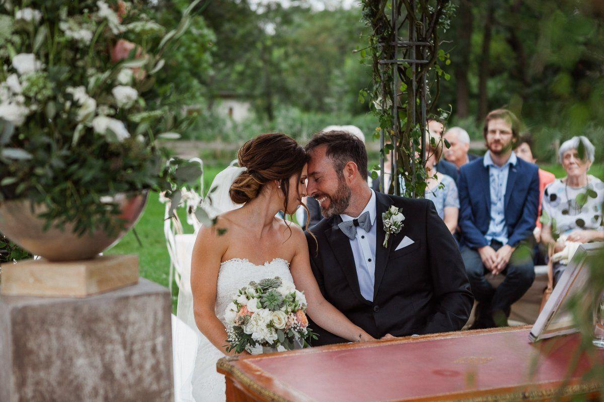 Eine Braut und ein Bräutigam küssen sich bei ihrer Hochzeitszeremonie.