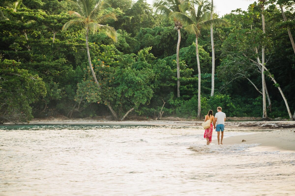 Paar spaziert Hand in Hand am Strand im Indischen Ozean.