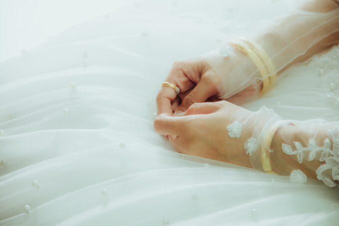 Eine Braut steckt ihren Ehering an ihren Finger.